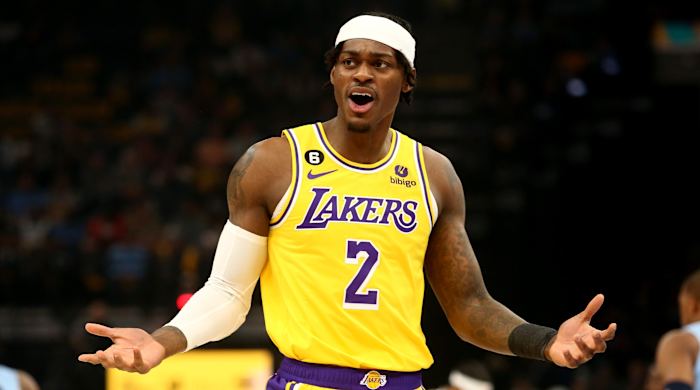 Lakers forward Jarred Vanderbilt holds up his hands during a game against the Grizzlies.